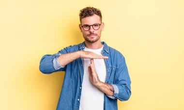 Genç, yakışıklı, İspanyol görünümlü, ciddi, sert, kızgın ve hoşnutsuz bir adam.