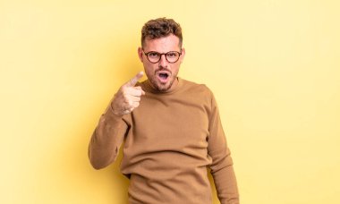 Genç, yakışıklı, İspanyol bir adam kızgın agresif bir ifadeyle kameraya bakıyor. Öfkeli, çılgın bir patron gibi görünüyor.