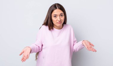 hispanic pretty woman feeling clueless and confused, having no idea, absolutely puzzled with a dumb or foolish look