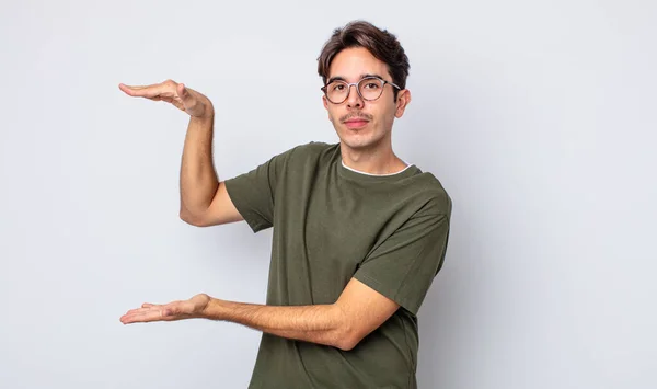 Young Handsome Hispanic Man Holding Object Both Hands Side Copy — Stock Photo, Image