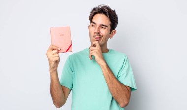 Genç İspanyol adam düşünüyor, kuşkulu ve şaşkın hissediyor. 2022 planlayıcı kavramı