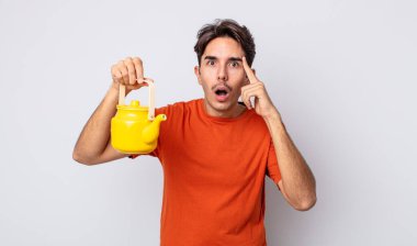 Genç İspanyol adam şaşırmış görünüyor, yeni bir düşünce, fikir ya da konsept keşfediyor. çaydanlık konsepti