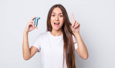 Genç ve güzel bir kadın bir fikri fark ettikten sonra mutlu ve heyecanlı bir dahi gibi hissediyor. astım konsepti