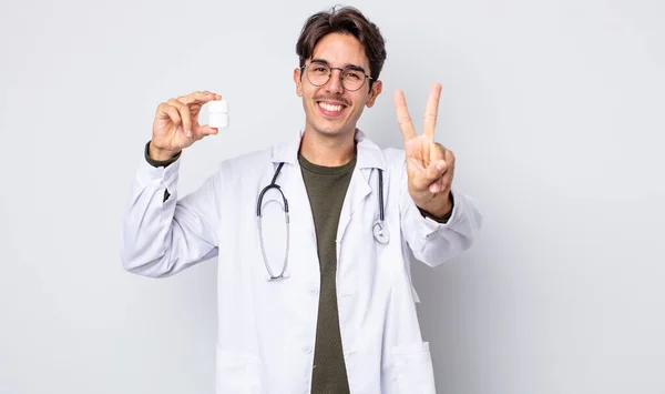 Młody Latynos Uśmiecha Się Wygląda Przyjaźnie Pokazuje Numer Dwa Lekarz — Zdjęcie stockowe