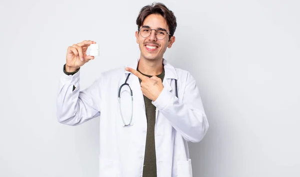 Young Hispanic Man Smiling Cheerfully Feeling Happy Pointing Side Physician — Stock Photo, Image