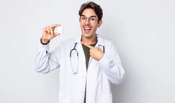 Young Hispanic Man Looking Excited Surprised Pointing Side Physician Pills — Stock Photo, Image