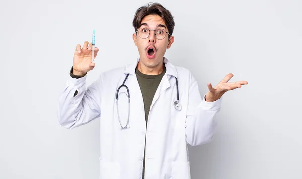 Young Hispanic Man Amazed Shocked Astonished Unbelievable Surprise Doctor Syringe — Stock Photo, Image
