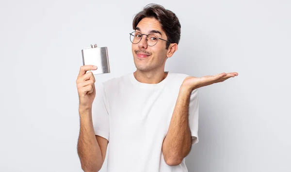 Young Hispanic Man Feeling Puzzled Confused Doubting Alcohol Flask Concept — Stock Photo, Image