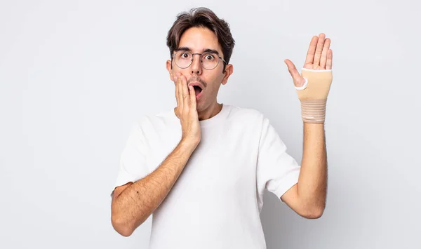 Young Hispanic Man Feeling Shocked Scared Hand Bandage Concept — Stock Photo, Image