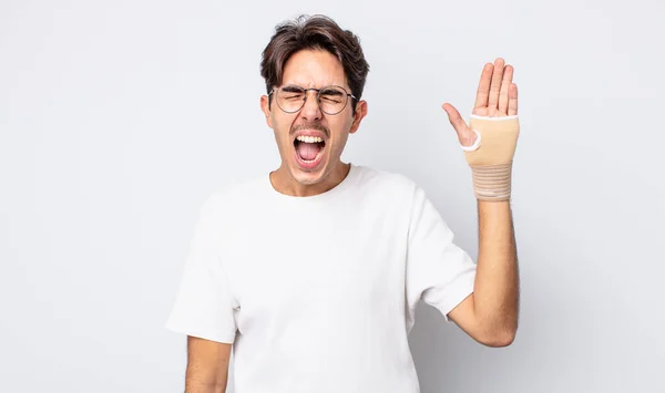 Young Hispanic Man Shouting Aggressively Looking Very Angry Hand Bandage — Stock Photo, Image