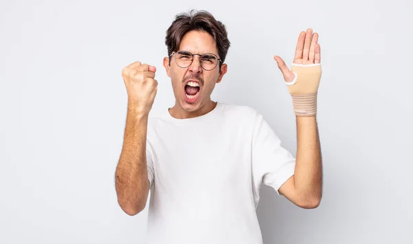 Young Hispanic Man Shouting Aggressively Angry Expression Hand Bandage Concept — Stock Photo, Image