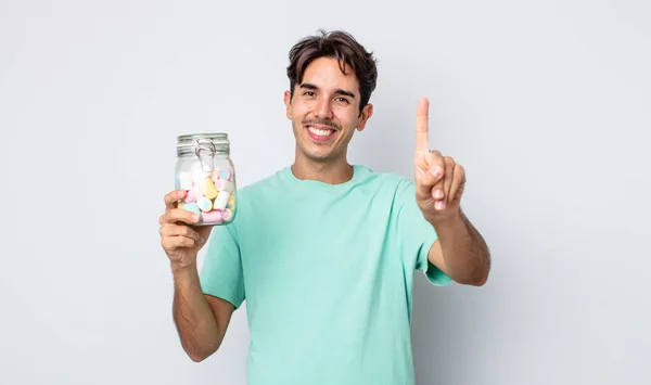 Jeune Homme Hispanique Souriant Regardant Amical Montrant Numéro Gelée Bonbons — Photo