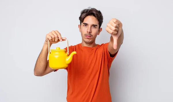 Young Hispanic Man Feeling Cross Showing Thumbs Teapot Concept — Stock Photo, Image