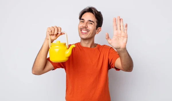 Молодой Латиноамериканец Счастливо Улыбается Машет Рукой Приветствует Приветствует Концепция Чайника — стоковое фото