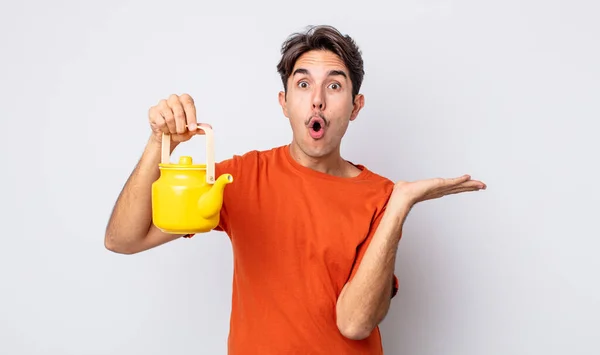 Young Hispanic Man Looking Surprised Shocked Jaw Dropped Holding Object — Stock Photo, Image