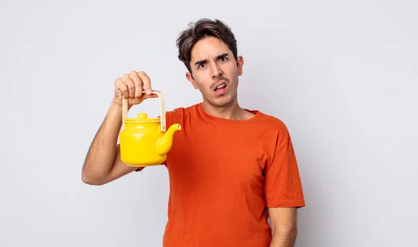 Young Hispanic Man Feeling Puzzled Confused Teapot Concept — Stock Photo, Image