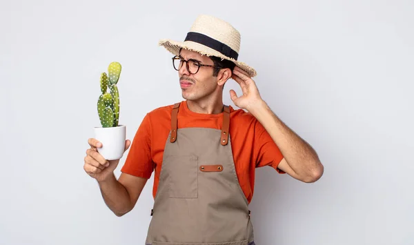 Young Hispanic Man Smiling Happily Daydreaming Doubting Gardener Cactus Concept — Stock Photo, Image
