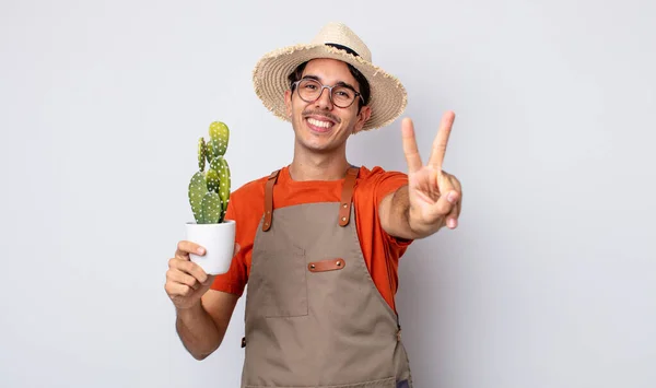 Young Hispanic Man Smiling Looking Happy Gesturing Victory Peace Gardener — Stock Photo, Image