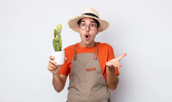 Young Hispanic Man Amazed Shocked Astonished Unbelievable Surprise Gardener Cactus — Stock Photo, Image