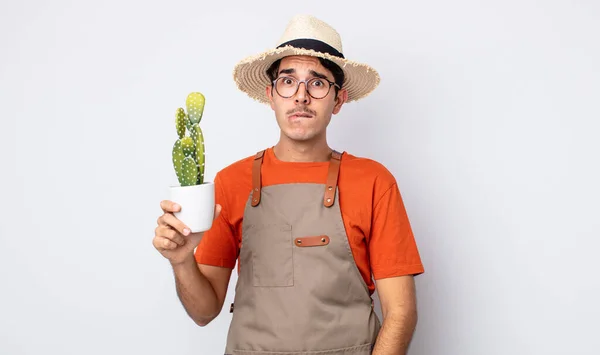 Young Hispanic Man Looking Puzzled Confused Gardener Cactus Concept — Stock Photo, Image