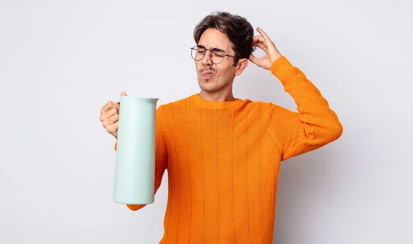 Young Hispanic Man Feeling Puzzled Confused Scratching Head Thermos Concept — Stock Photo, Image