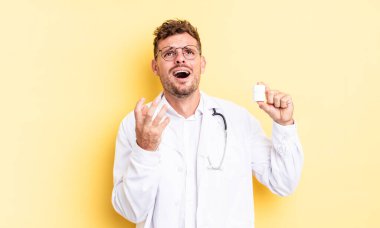 Genç yakışıklı adam umutsuz, sinirli ve stresli görünüyor. Hekim hapları şişesi konsepti