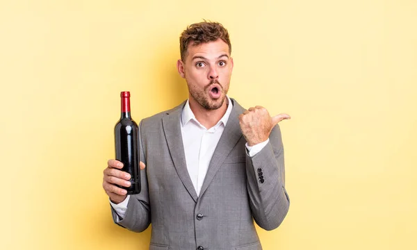 Young Handsome Man Looking Astonished Disbelief Bottle Wine Concept — Stock Photo, Image