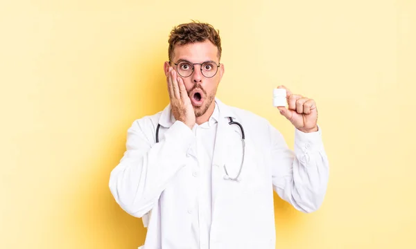 Young Handsome Man Feeling Shocked Scared Physician Pills Bottle Concept — Stock Photo, Image