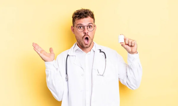 Young Handsome Man Looking Surprised Shocked Jaw Dropped Holding Object — Stock Photo, Image