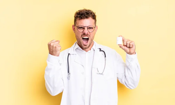 Ένας Νεαρός Όμορφος Άντρας Φωνάζει Επιθετικά Θυμωμένη Έκφραση Γιατρός Χάπια — Φωτογραφία Αρχείου