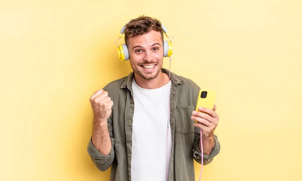 Young Handsome Man Feeling Shocked Laughing Celebrating Success Headphones Smartphone — Stock Photo, Image