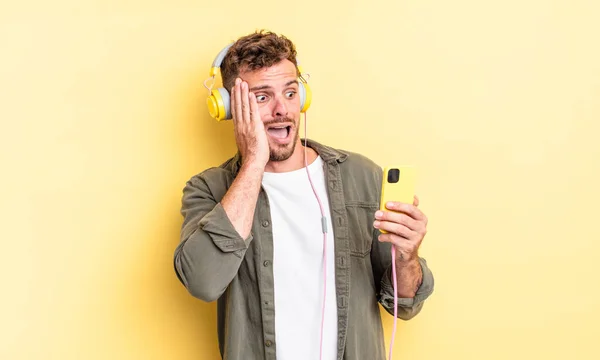 Mladý Pohledný Muž Pocit Šťastný Vzrušený Překvapený Sluchátka Smartphone Koncept — Stock fotografie
