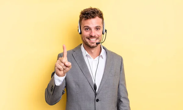 Young Handsome Man Smiling Looking Friendly Showing Number One Telemarketer — Stock Photo, Image
