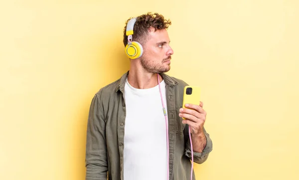 Young Handsome Man Profile View Thinking Imagining Daydreaming Headphones Smartphone — Stock Photo, Image