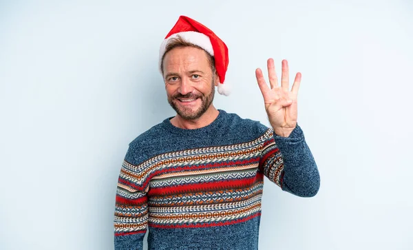 中年のハンサムな男笑顔と友好的に見える 4番目を示す クリスマスのコンセプト — ストック写真