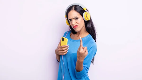 Pretty Hispanic Woman Feeling Angry Annoyed Rebellious Aggressive Smartphone Headphones — Stock Photo, Image