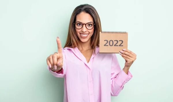 Pretty Hispanic Woman Smiling Proudly Confidently Making Number One 2022 — Stock Photo, Image
