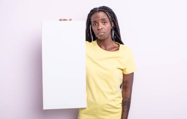 Güzel siyah bir kadın üzgün ve mızmızlanıyor. Mutsuz bir bakışı var ve ağlıyor. boş tuval konsepti