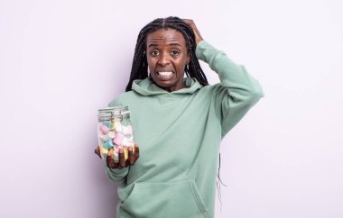 Güzel siyah kadın stresli, endişeli ya da korkmuş hissediyor, elleri başının üstünde. jöle şekeri konsepti