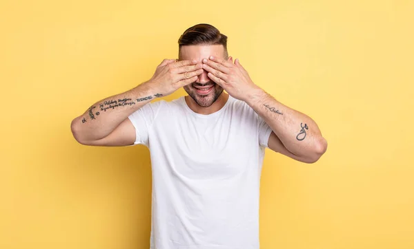 Jovem Bonito Homem Sorrindo Sentindo Feliz Cobrindo Olhos Com Duas — Fotografia de Stock