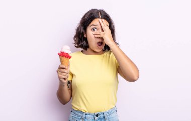 pretty young woman looking shocked, scared or terrified, covering face with hand. ice cream concept clipart