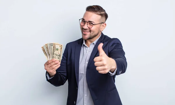 Young Handsome Man Feeling Proud Smiling Positively Thumbs Dollar Banknotes — Stock Photo, Image