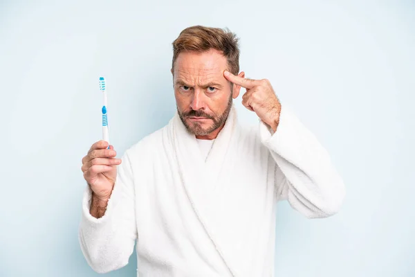 Middle Age Man Feeling Confused Puzzled Showing You Insane Toothbrush — Stockfoto