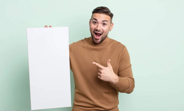 Young Handsome Man Looking Excited Surprised Pointing Side Empty Canvas — Stock Photo, Image