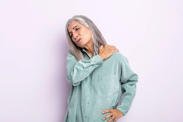 middle age gray hair woman feeling tired, stressed, anxious, frustrated and depressed, suffering with back or neck pain