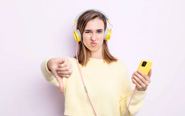 Young Pretty Woman Feeling Cross Showing Thumbs Headphones Phone Concept — Stock Photo, Image