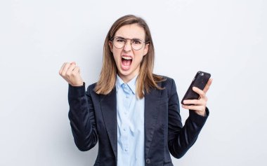 Genç ve güzel bir kadın sinirli bir ifadeyle agresif bir şekilde bağırıyor. iş kavramı