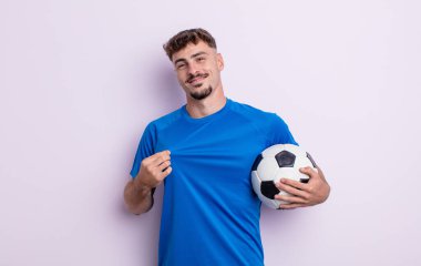 Genç yakışıklı adam kibirli, başarılı, pozitif ve gururlu görünüyor. futbol kavramı