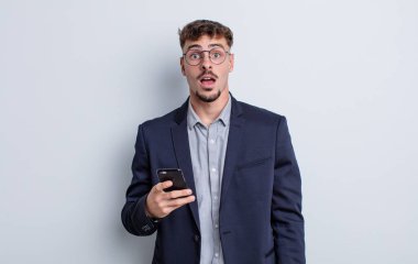 young handsome man looking very shocked or surprised. business concept