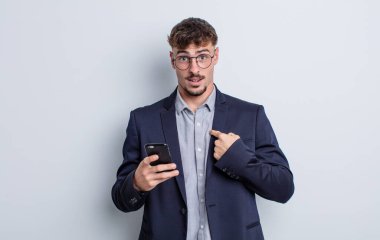 young handsome man feeling happy and pointing to self with an excited. business concept